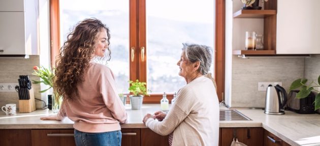 A teenage girl with grandmother at home.