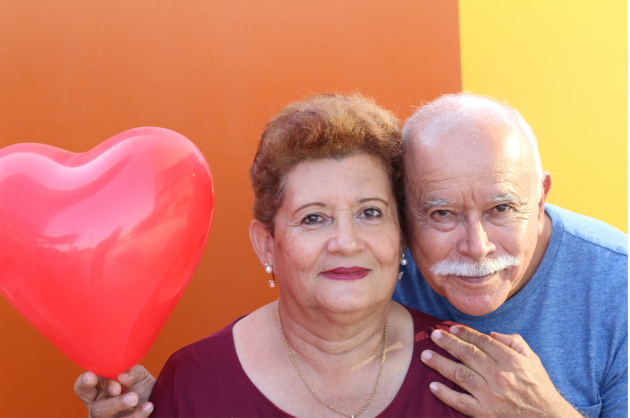 caregivers seniors celebrating Valentine's Day with heart balloon