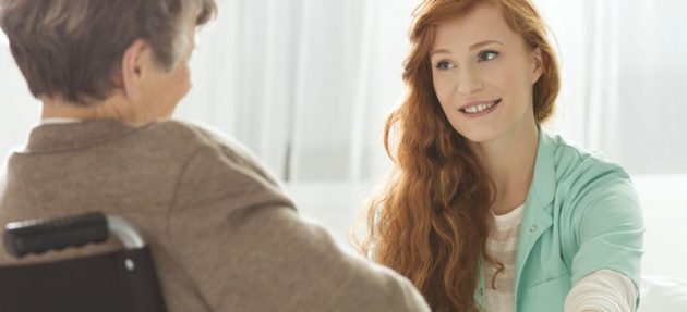 Nurse looking at elder woman